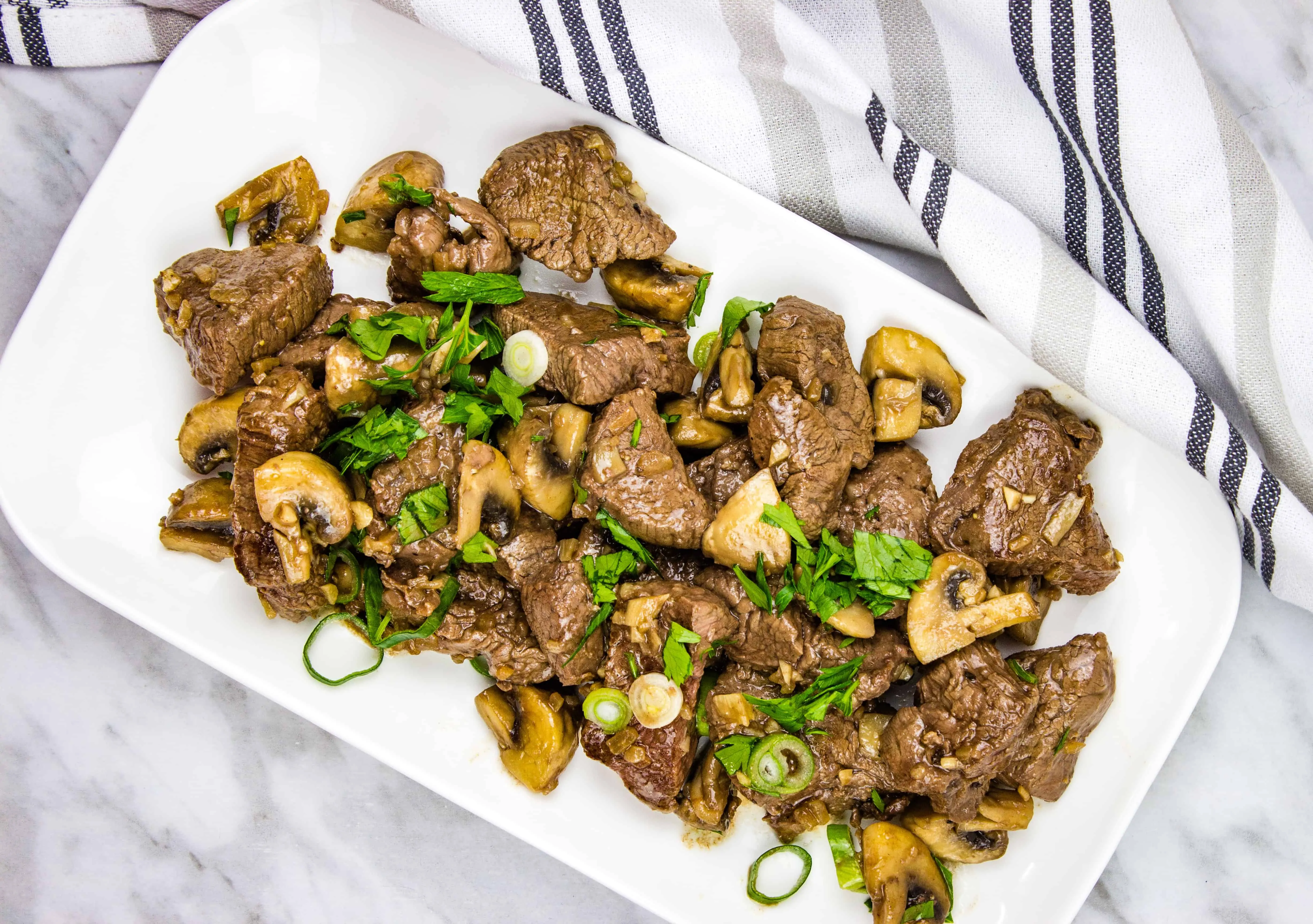 keto Garlic steak & mushrooms on a rectangular platter