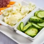 keto pickles on a tray with cauliflower, meat and cheese