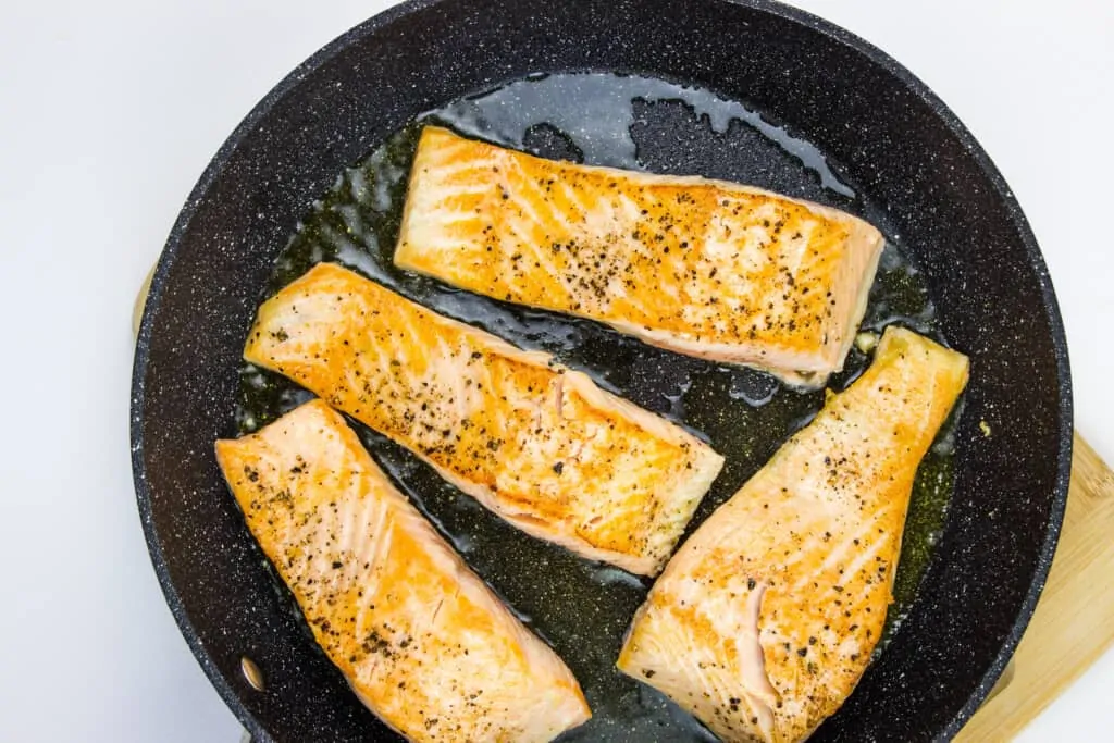 Sautee the seasoned salmon filets in a bit of cooking oil and set aside