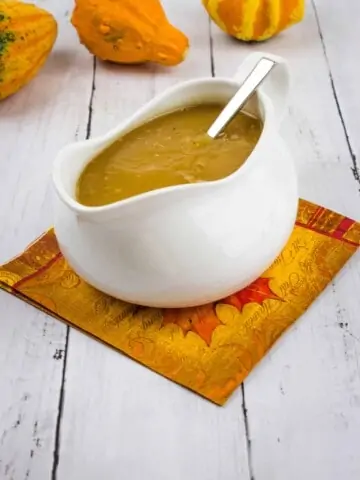 keto turkey gravy in a gravy boat with gourds in the background
