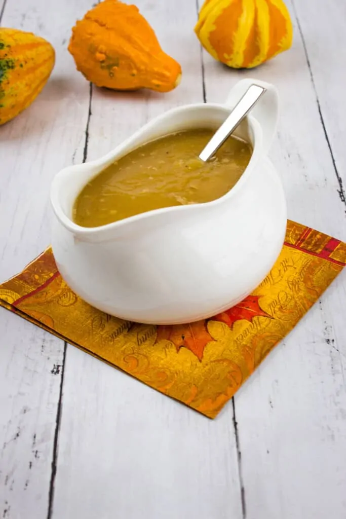 keto turkey gravy in a gravy boat with gourds in the background