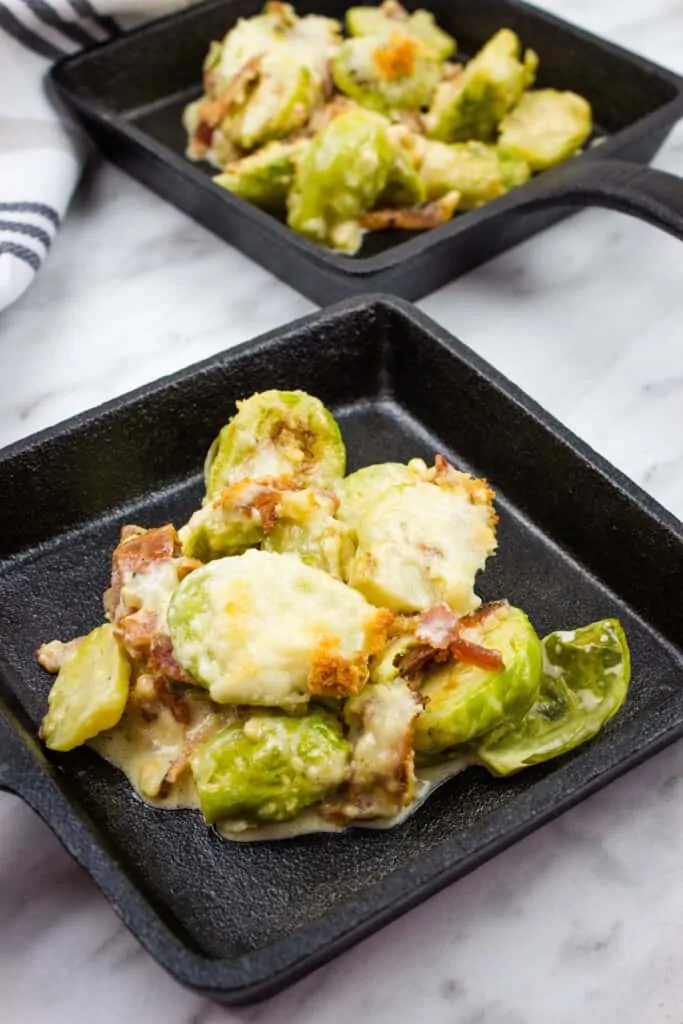 Parmesan Brussels sprouts with bacon in cast iron serving dishes