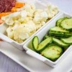 Keto Cauliflower Pickles on a plater with cucumbers, cheese and salami