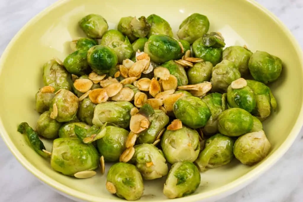 keto brussels sprouts with almonds & brown butter in a serving dish