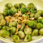 keto brussels sprouts with almonds & brown butter in a serving dish