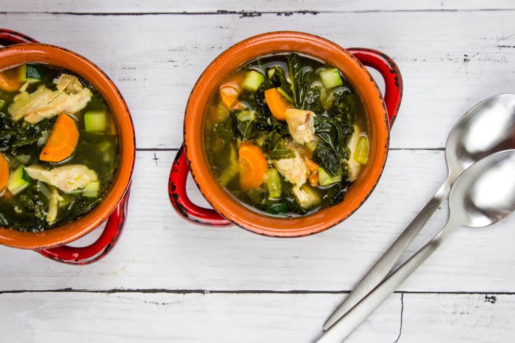 keto leftover turkey vegetable soup in bowls with spoons