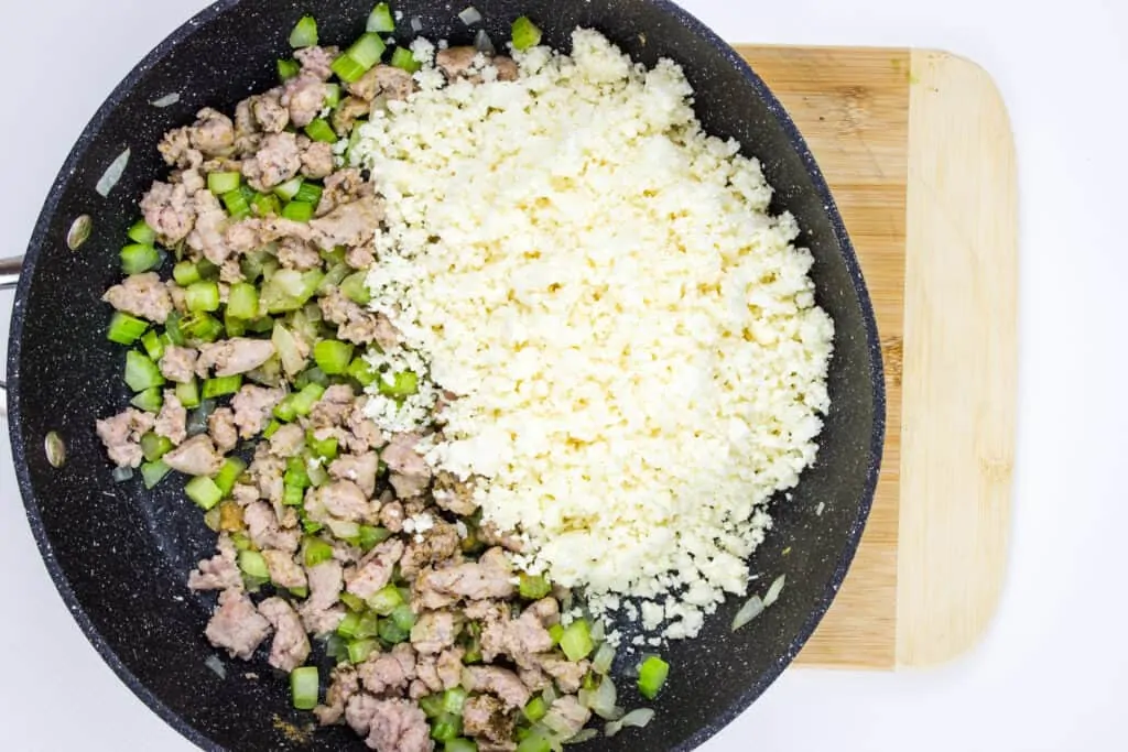 Add the riced cauliflower to the cooked sausage mixture