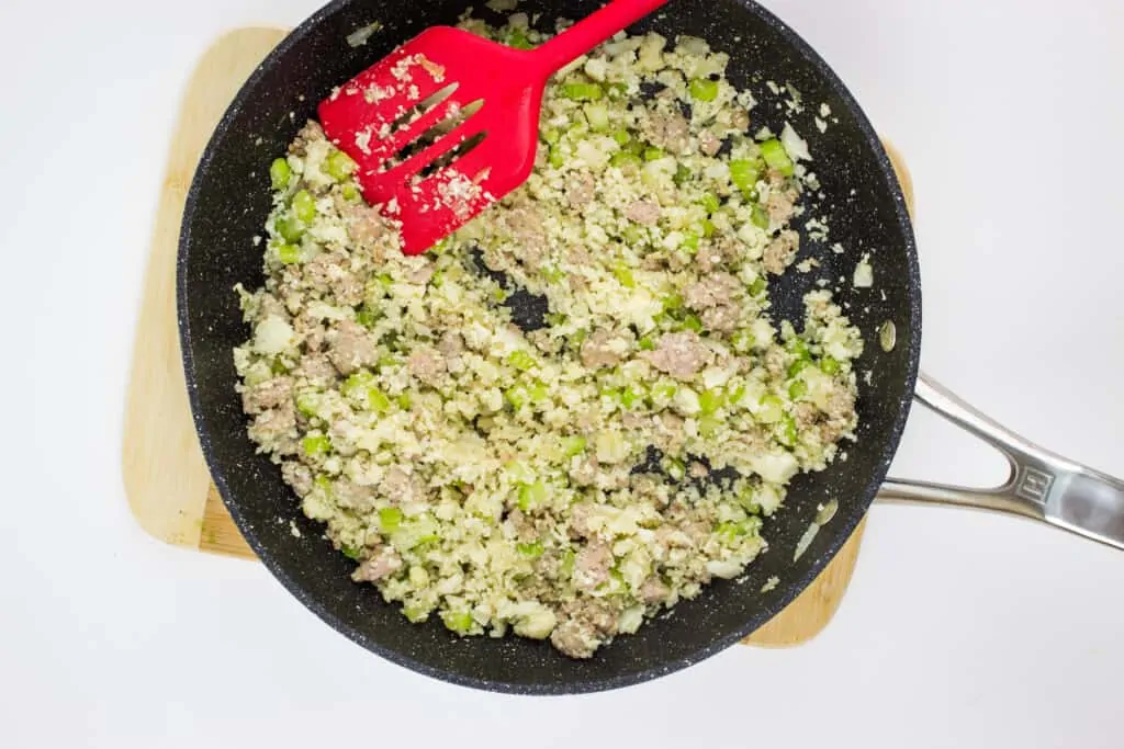 keto stuffing cooked in a skillet with a red flipper
