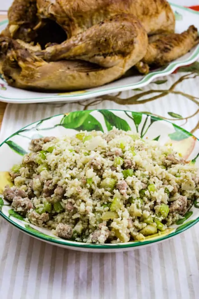 Keto Stuffing in a Bowl with a turkey in the background