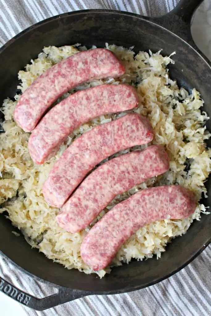 sausage and sauerkraut in a dish ready for the oven