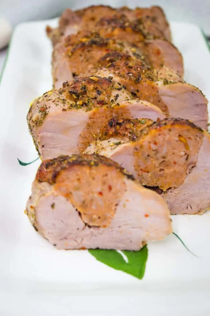 sausage stuffed pork tenderloin on a platter