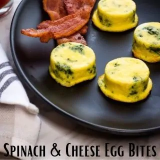 keto spinach and cheese egg bites on a black plate