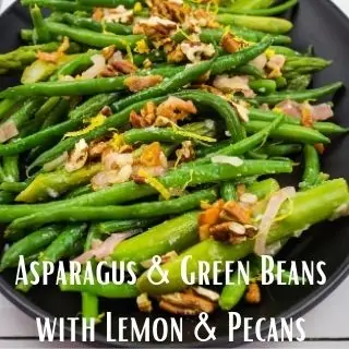 Asparagus & Green beans with Lemon & Pecans on a black serving plate