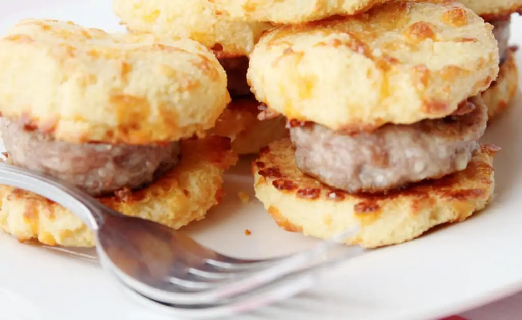 closeup of keto breakfast sandwiches with sausage with a fork in the foreground