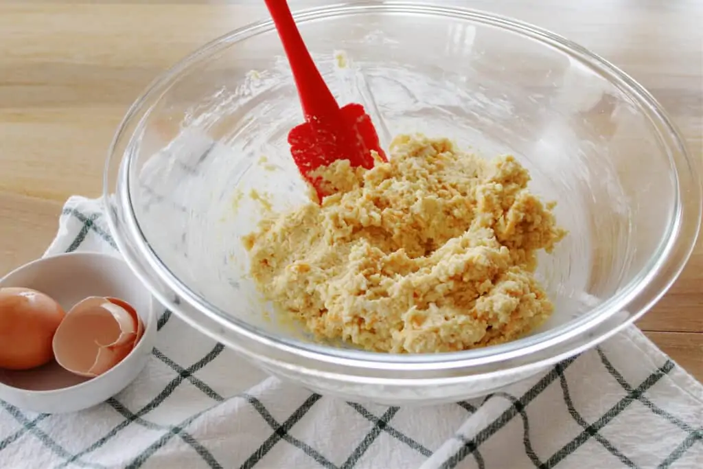 the mixed biscuit batter in a bowl with a spatula on the side