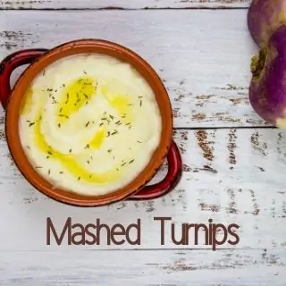 mashed turnips in a rustic bowl with turnips in the background