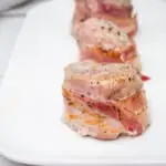 bacon wrapped pork tenderloin on a plate