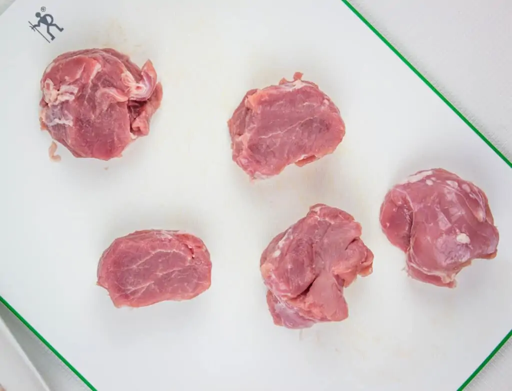 pork tenderloin medallions on a cutting board