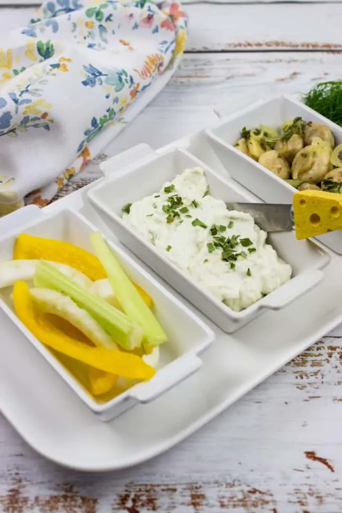 keto blue cheese dip on a serving tray with vegetable sticks and marinated mushrooms