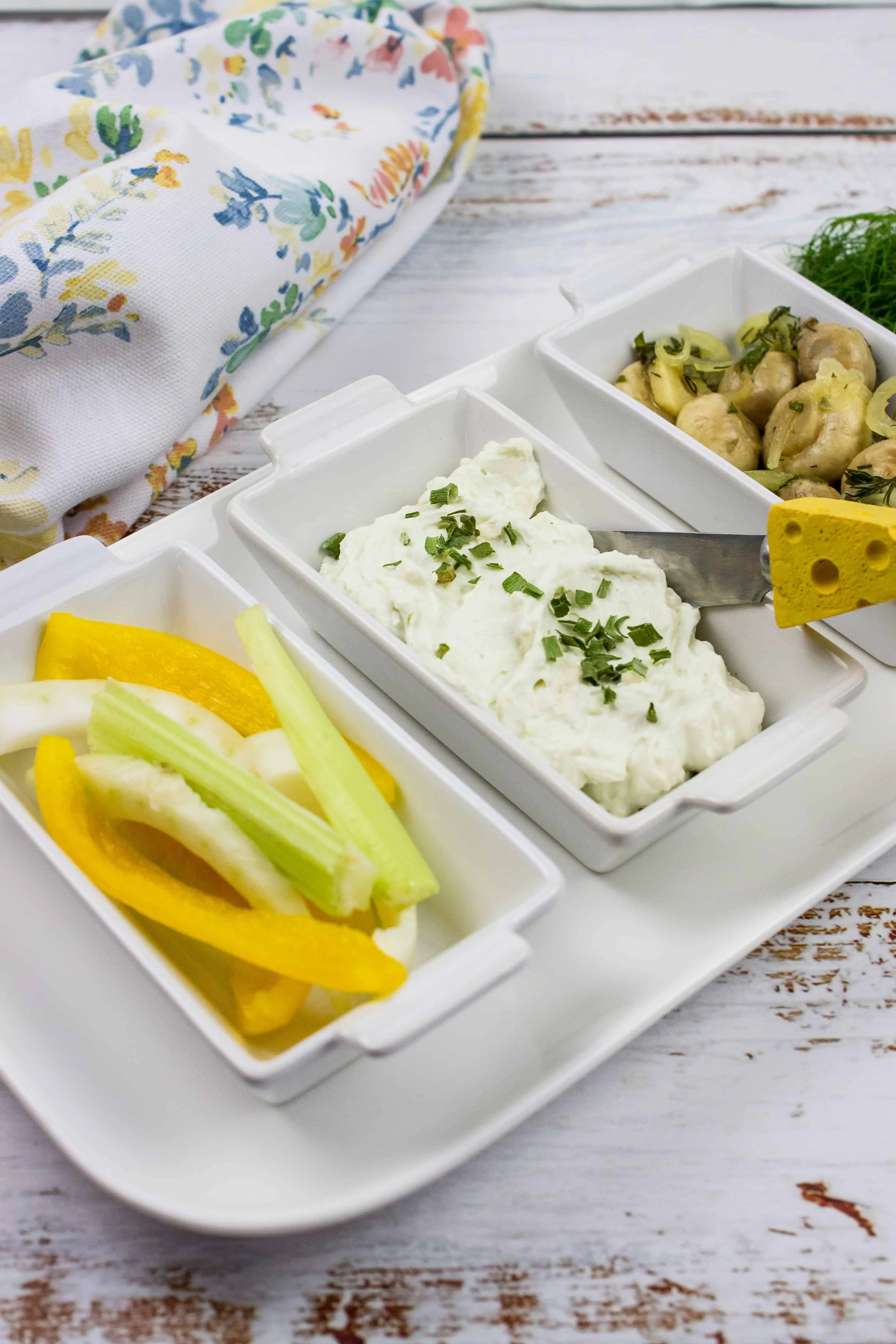 keto blue cheese dip on a serving tray with vegetable sticks and marinated mushrooms