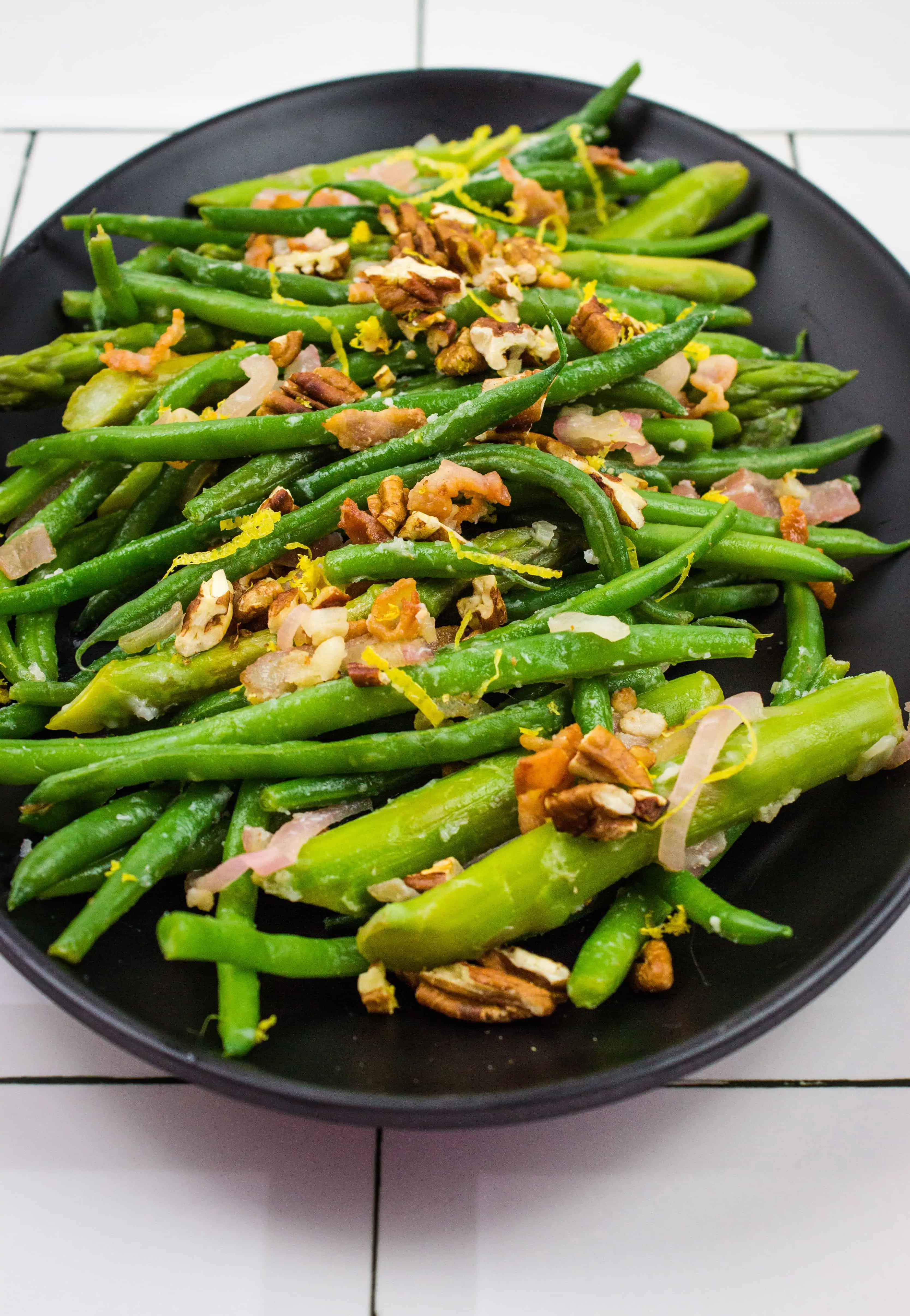 keto asparagus and green beans on a black plate