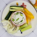 keto blue cheese dip in a serving bowl surrounded by cut vegetables
