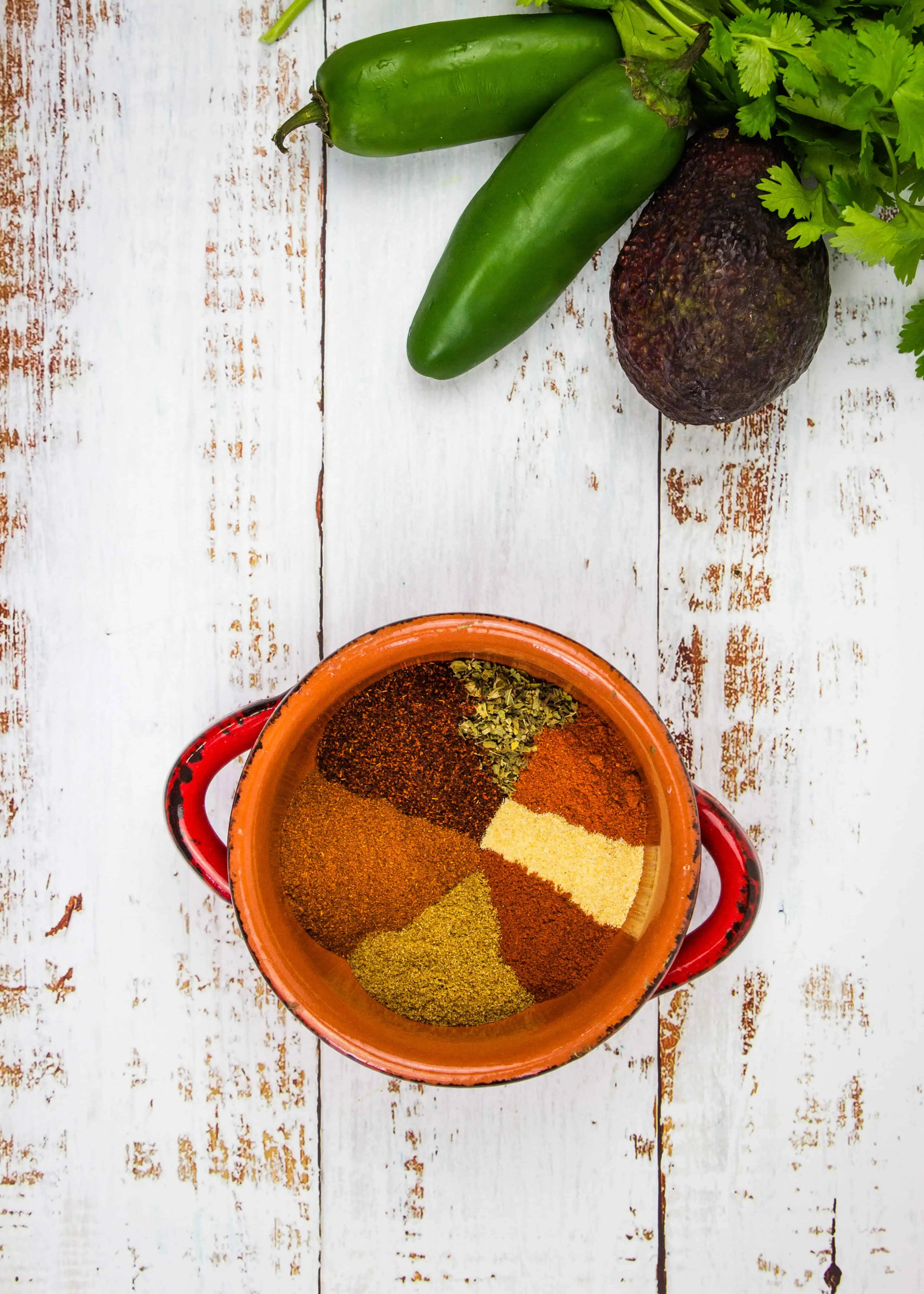 keto chili spice mix on a table with veggies in the background