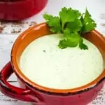 keto creamy jalapeno dip in a rustic bowl with tortilla chips in the background