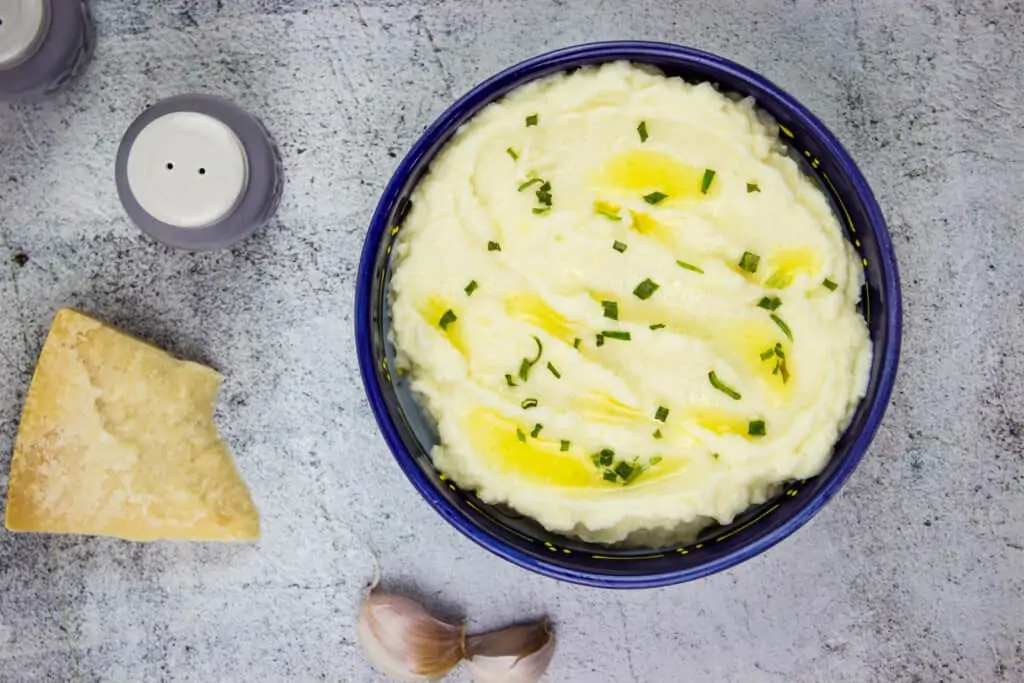 keto mashed cauliflower in a blue serving bowl