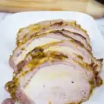 brown sugar mustard glaze pork roast sliced on a platter