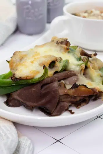 Keto Philly Cheesesteak Stacks on a plate with soup in the background