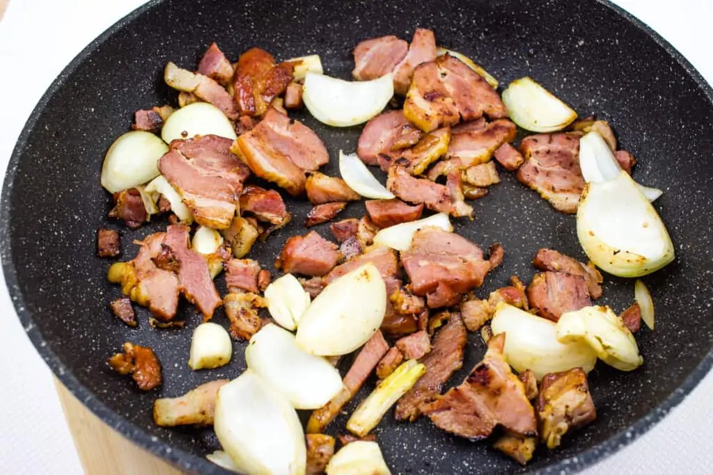 Fry the onions, garlic, and bacon.