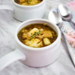 keto french onion soup in a white soup bowl with a second serving in the background