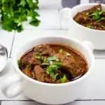 hungarian keto goulash in white serving dishes