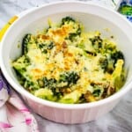 keto broccoli casserole with parmesan and bacon in a casserole dish