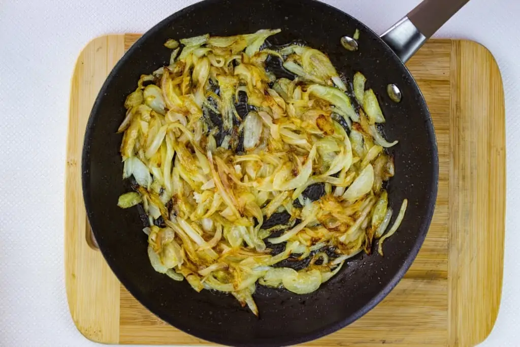 caramelizing onions in a black skillet