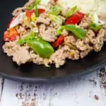 keto italian turkey and peppers on a black plate with a side of cauliflower rice