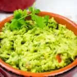 a closeup of easy keto guacamole in a rustic bowl