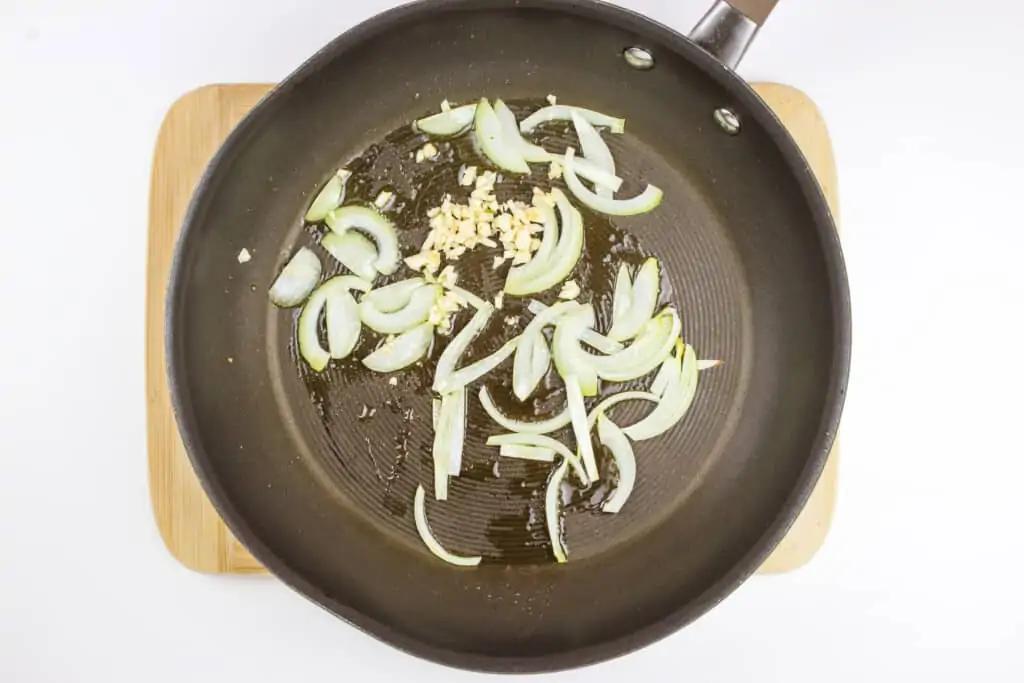 cooking onions and garlic in a skillet