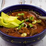 easy keto chili in a bowl with avocado on top