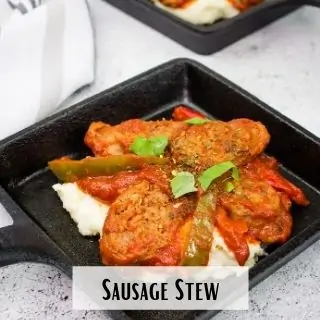 sausage stew on a black serving plate