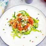 keto baked feta pasta with tomatoes on a bed of zucchini noodles