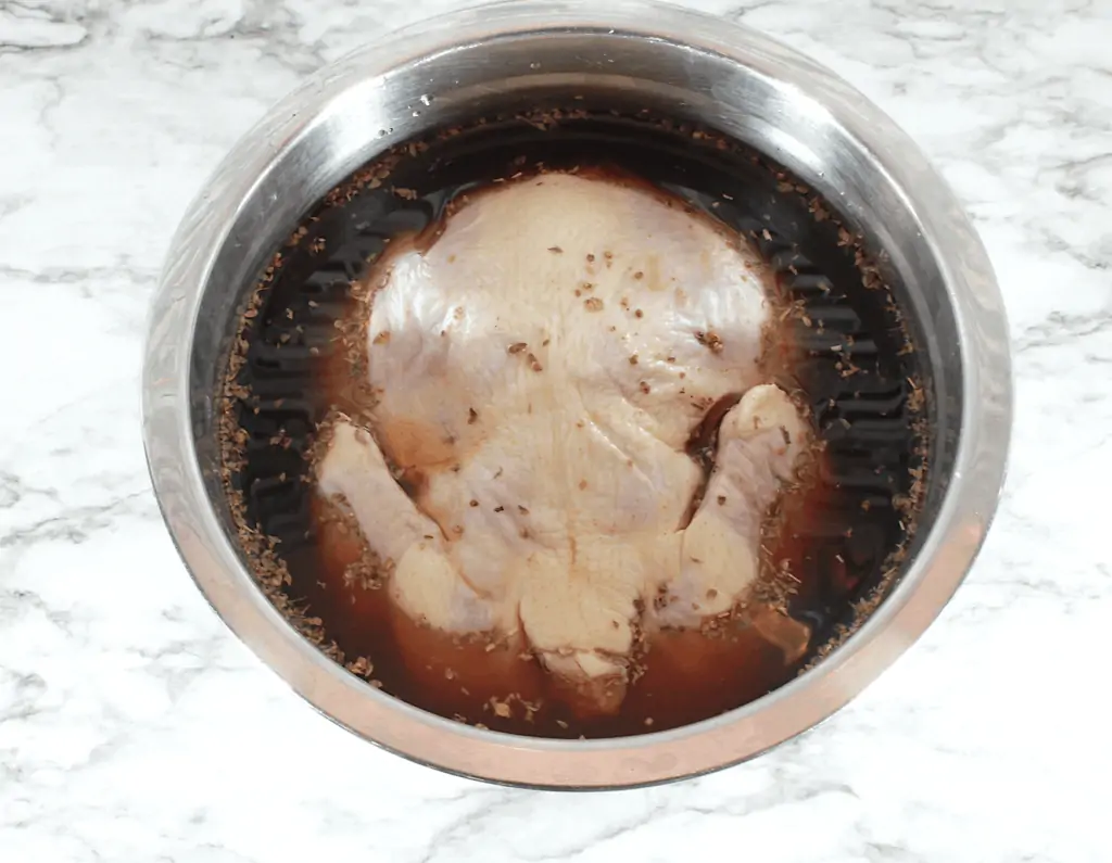 a chicken soaking in the brine