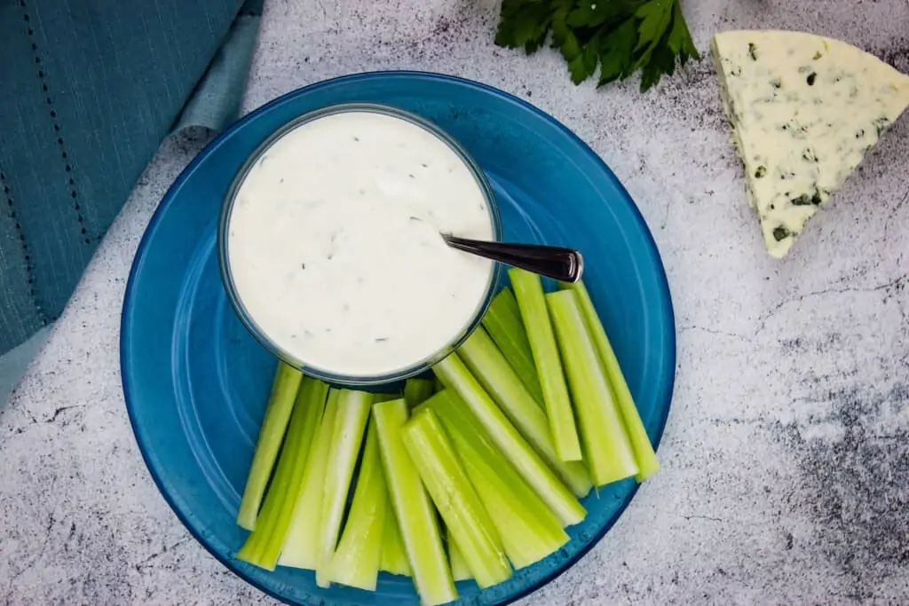 keto blue cheese dressing in a bowl with veggies nearby