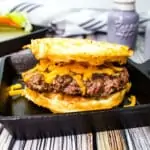 a keto butter burger topped with cheese in a black skillet