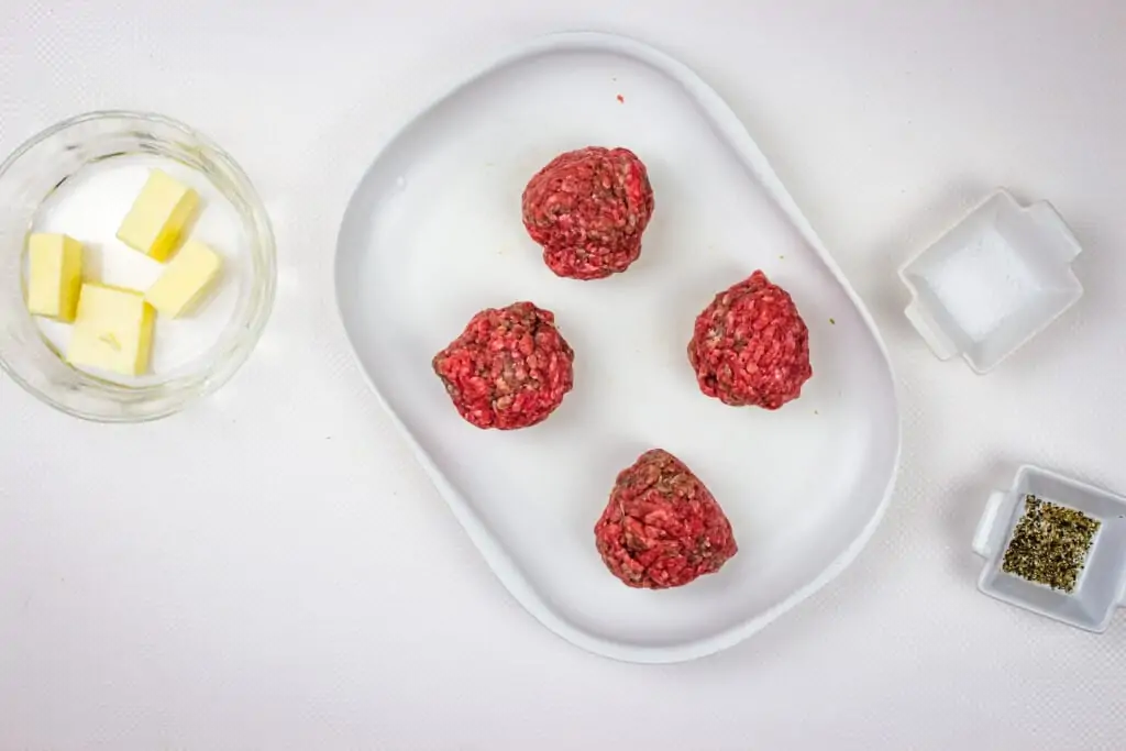 four portions of lean ground beef in balls