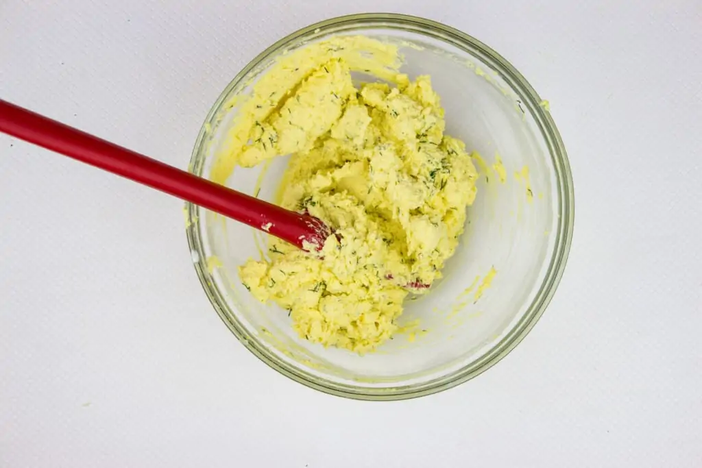 A bowl with creamy filling mixed and ready to fill eggs