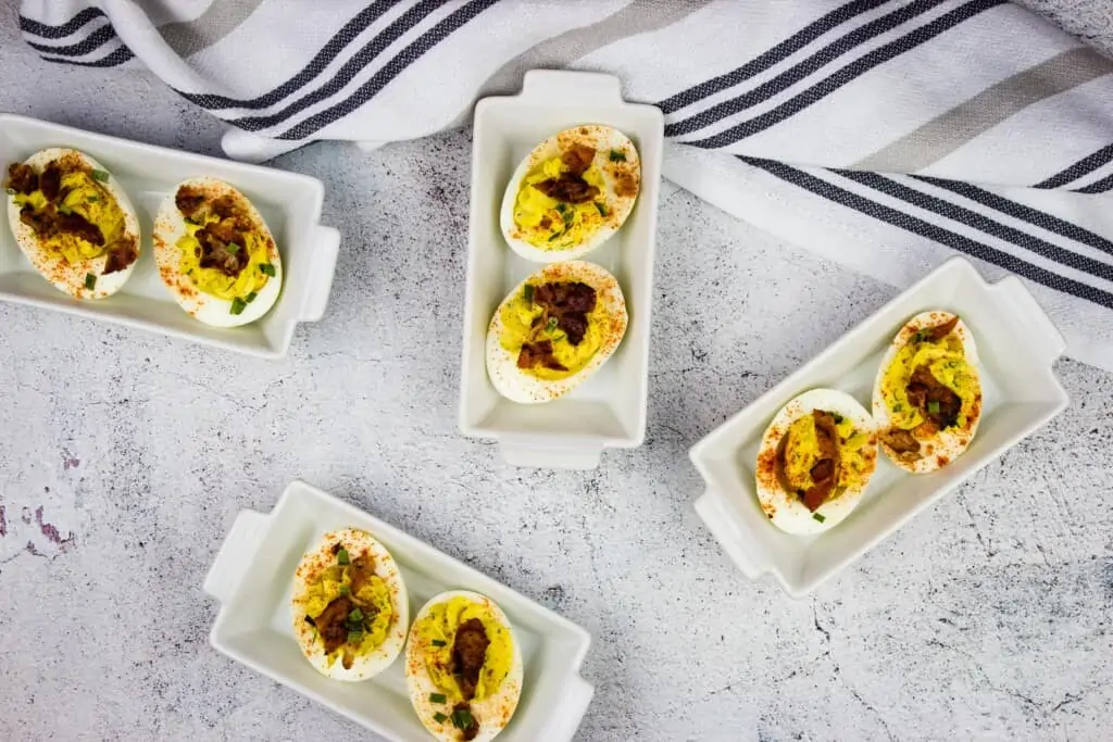 keto deviled eggs with bacon in small serving dishes