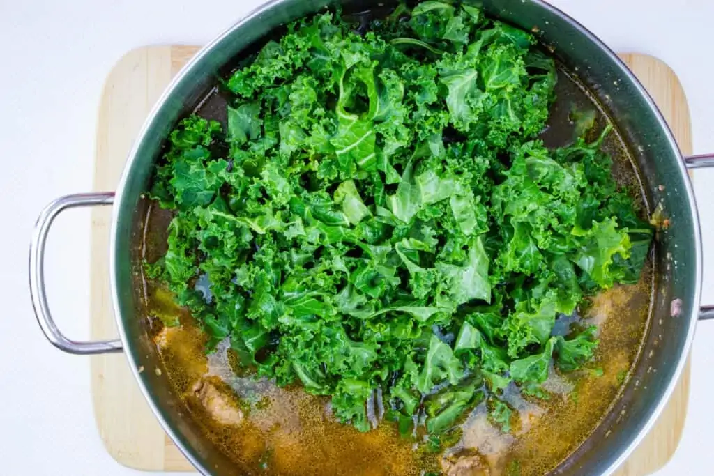 add the broth and water and kale to the pot