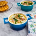 keto zuppa toscana soup recipe in a bowl with chaffles in the background